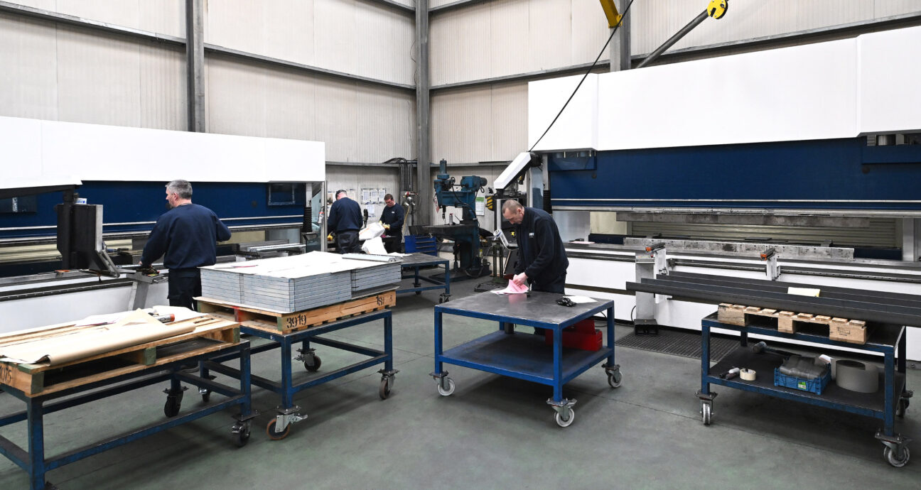 Workers using press brake machines